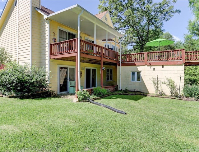 back of property with a yard and a deck