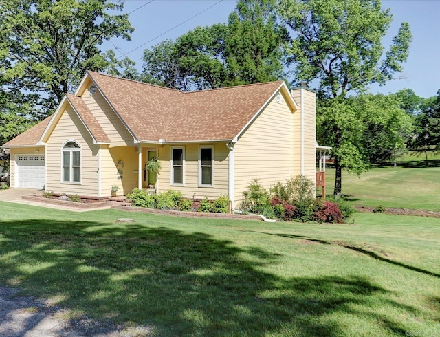 view of front of property featuring a front yard, roof with shingles, a chimney, and a garage