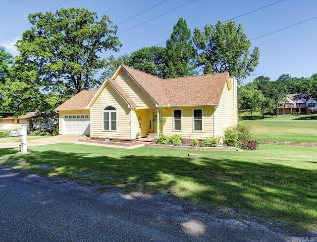 view of front of home with a front yard, a shingled roof, an attached garage, and driveway