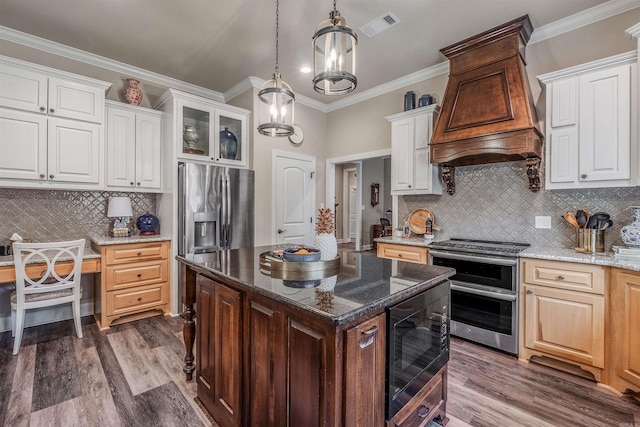 74 Greystone Blvd, Cabot, AR 72023 - kitchen with dark wood finished floors, visible vents, backsplash, appliances with stainless steel finishes, and premium range hood