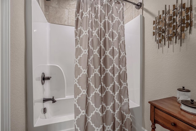 74 Greystone Blvd, Cabot, AR 72023 - bathroom featuring a textured wall and shower / bathtub combination with curtain