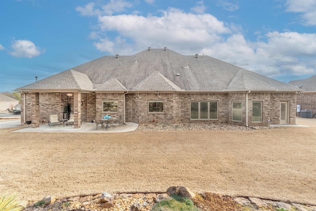 74 Greystone Blvd, Cabot, AR 72023 - rear view of house with central AC, roof with shingles, a patio, and brick siding