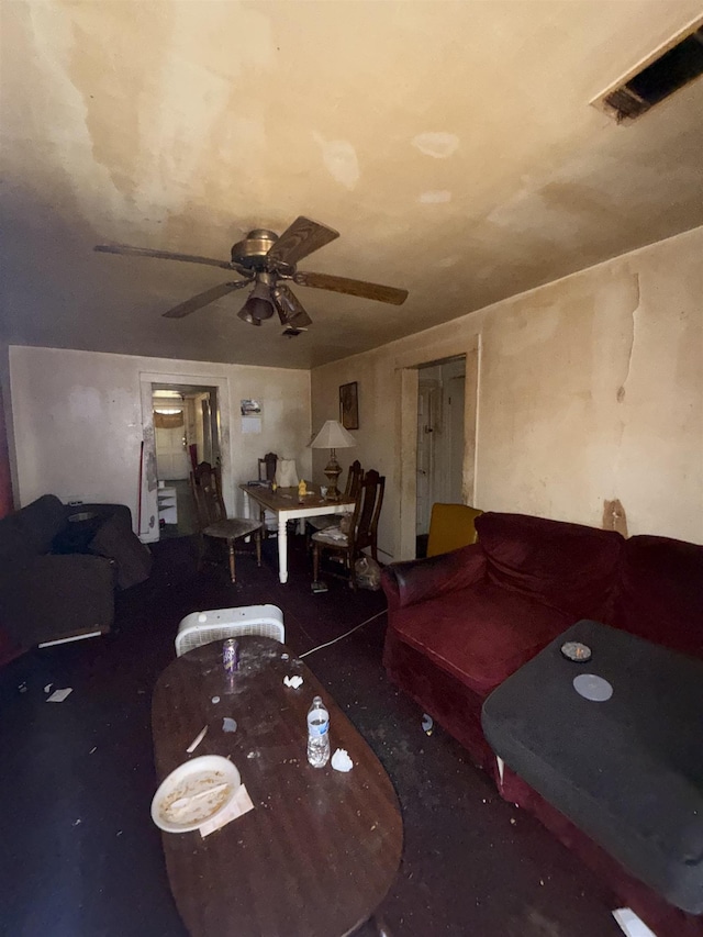 living area featuring visible vents and ceiling fan