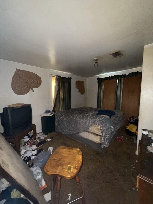 carpeted bedroom featuring visible vents