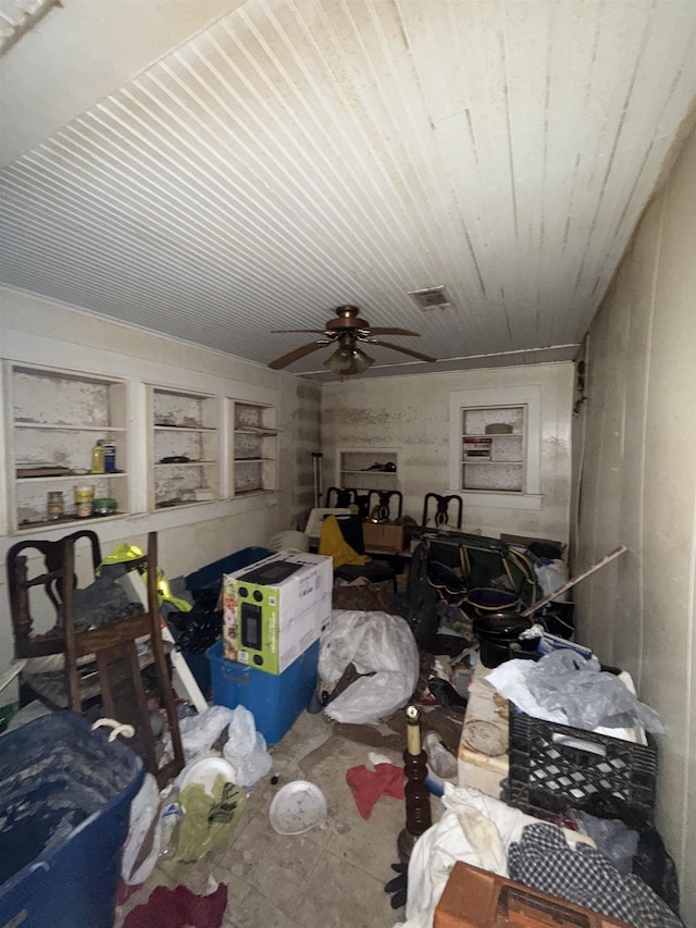 living room featuring ceiling fan and visible vents