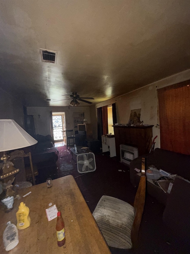 dining room featuring visible vents, a fireplace, and a ceiling fan