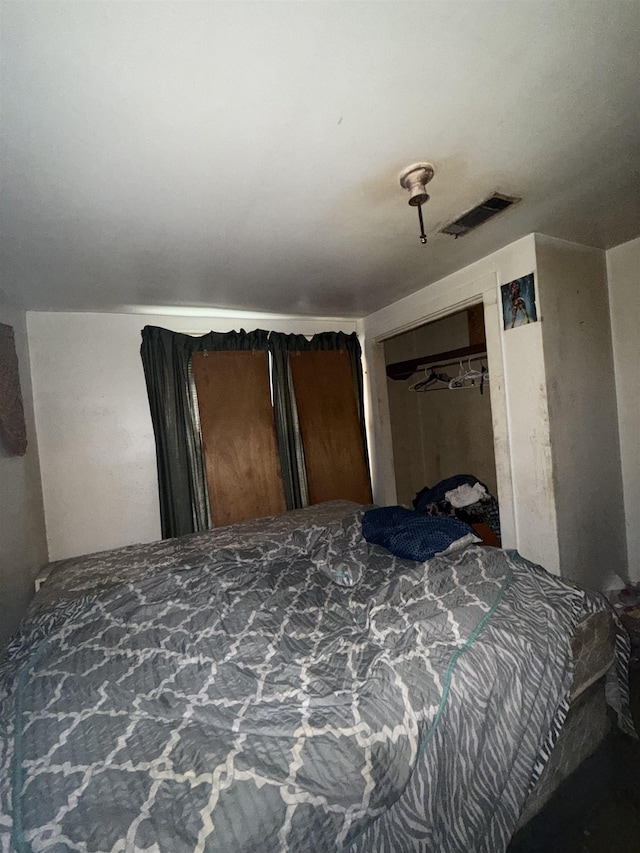 bedroom featuring a closet and visible vents