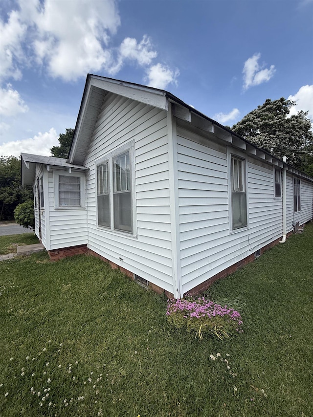 view of home's exterior featuring crawl space and a lawn