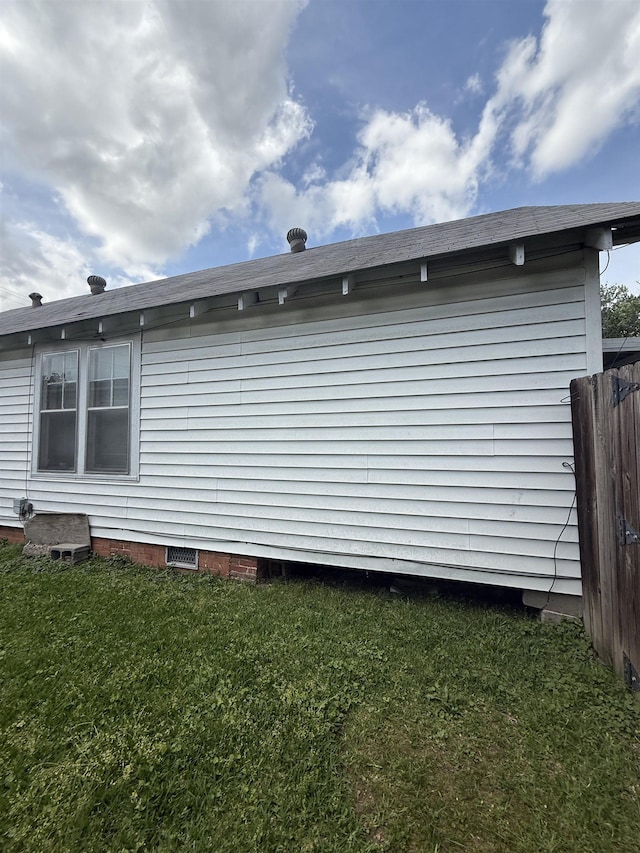 view of home's exterior featuring a yard, fence, and crawl space
