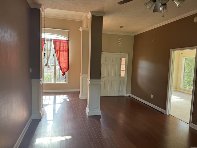 1360 Champions, Conway, AR 72034 - entryway with decorative columns, ornamental molding, dark wood-style floors, a ceiling fan, and baseboards