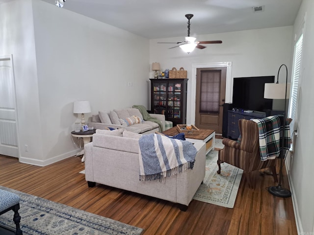 320 E 4th St, Lonoke, AR 72086 - living room with baseboards, visible vents, wood finished floors, and a ceiling fan