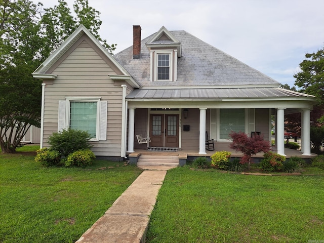 320 E 4th St, Lonoke, AR 72086 - view of front of house with a porch, a standing seam roof, french doors, and a chimney