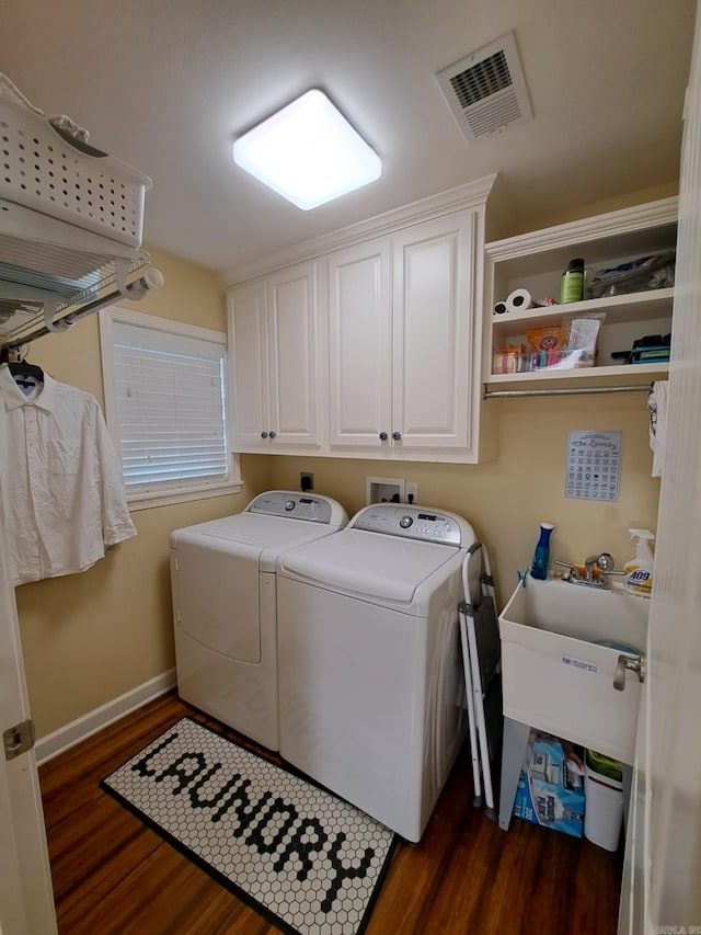 320 E 4th St, Lonoke, AR 72086 - laundry room featuring cabinet space, visible vents, separate washer and dryer, dark wood-style floors, and baseboards