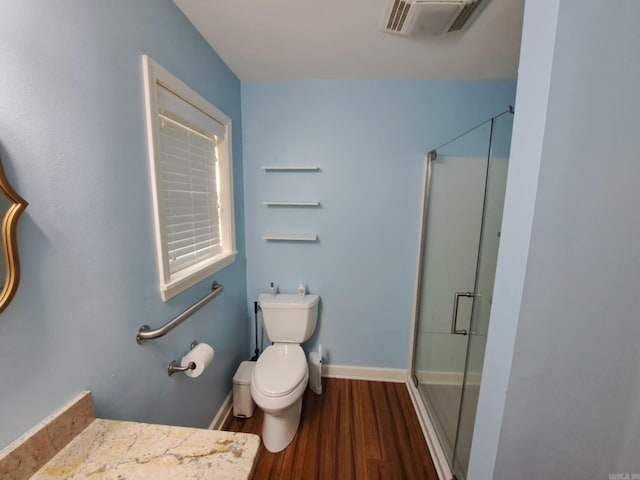 320 E 4th St, Lonoke, AR 72086 - full bath featuring toilet, wood finished floors, visible vents, a shower stall, and baseboards