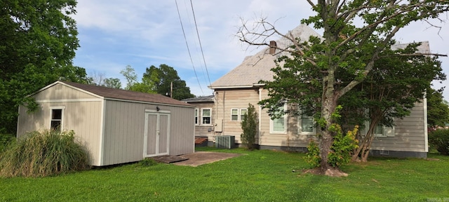 320 E 4th St, Lonoke, AR 72086 - exterior space featuring a storage shed, a yard, an outdoor structure, and central AC