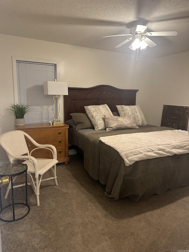 carpeted bedroom with a textured ceiling and a ceiling fan
