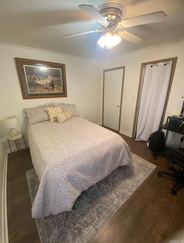 804 Elm St, Smackover, AR 71762 - bedroom featuring dark wood-style floors, ceiling fan, and baseboards