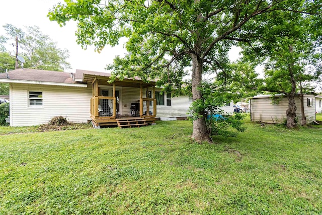 804 Elm St, Smackover, AR 71762 - back of property featuring a yard and a deck