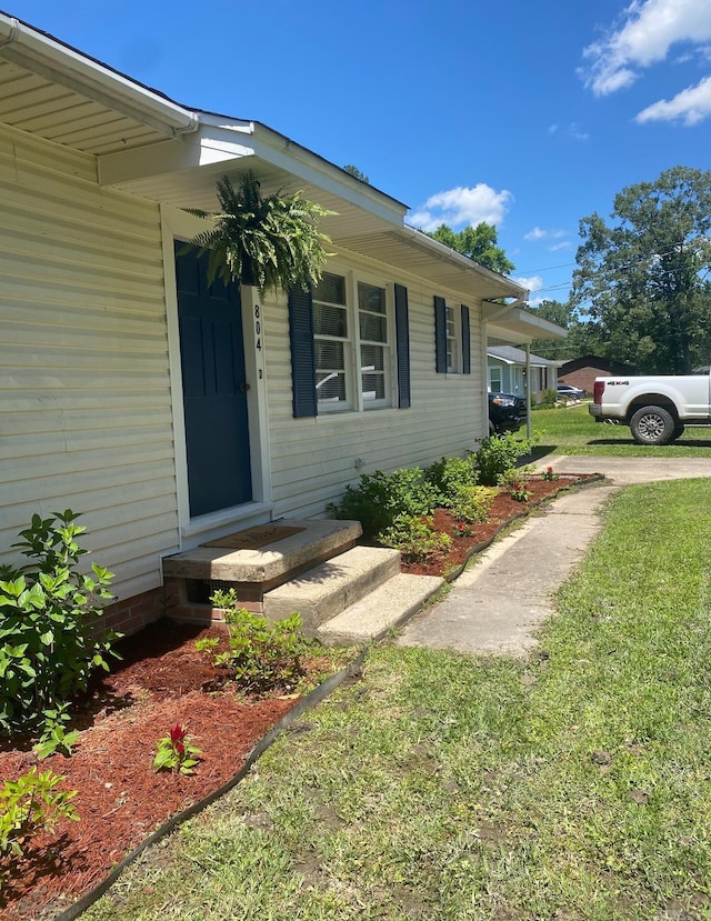 804 Elm St, Smackover, AR 71762 - view of exterior entry with a lawn