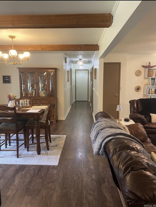 804 Elm St, Smackover, AR 71762 - dining room with dark wood-type flooring, a chandelier, beam ceiling, and baseboards