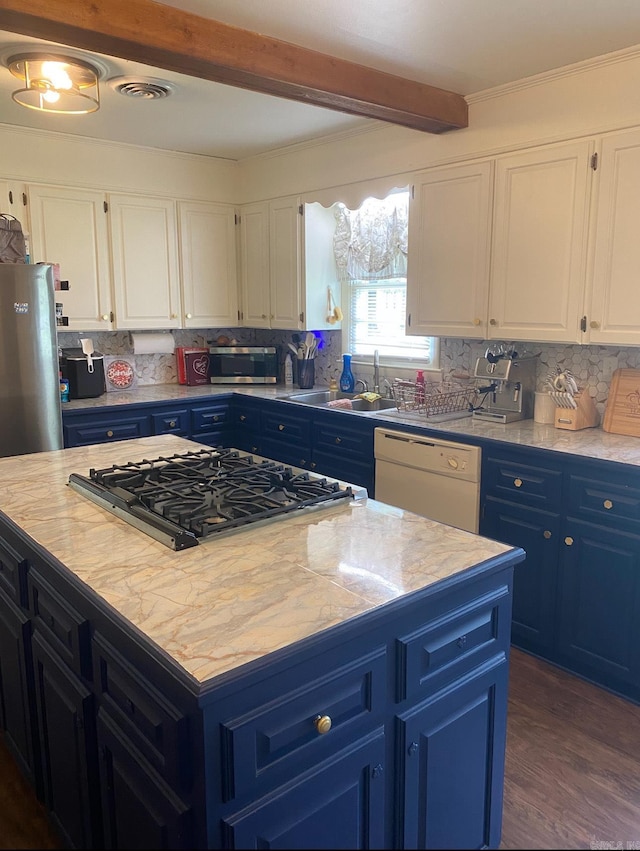 804 Elm St, Smackover, AR 71762 - kitchen featuring blue cabinetry, white dishwasher, stovetop, a sink, and beamed ceiling