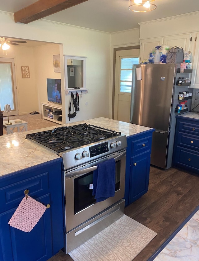 804 Elm St, Smackover, AR 71762 - kitchen featuring appliances with stainless steel finishes, blue cabinets, light countertops, a ceiling fan, and dark wood finished floors