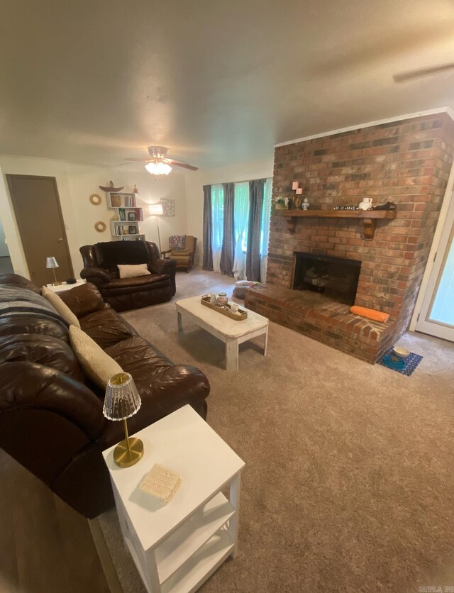 804 Elm St, Smackover, AR 71762 - living room with a fireplace, carpet flooring, and ceiling fan