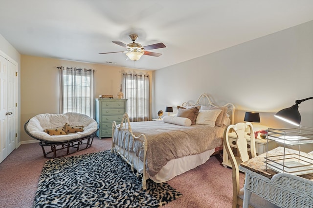 carpeted bedroom with baseboards, a ceiling fan, and visible vents