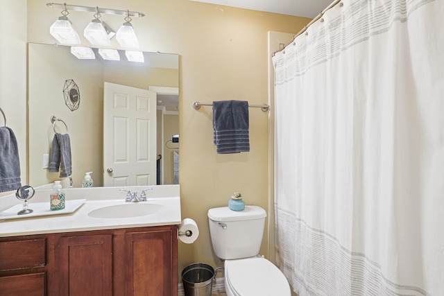 bathroom featuring toilet, curtained shower, and vanity