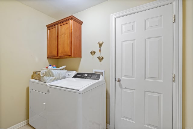 washroom featuring washing machine and dryer and cabinet space