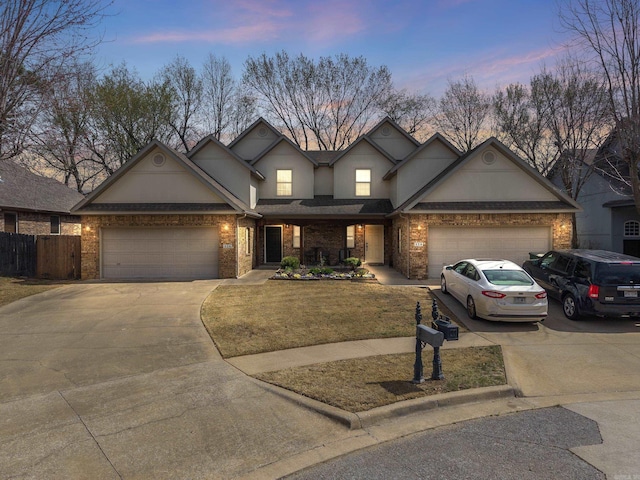 view of front of home featuring an attached garage, stucco siding, and driveway