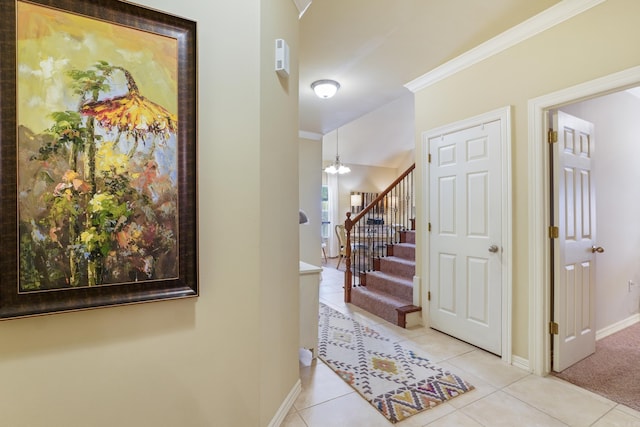 hallway featuring baseboards, stairs, ornamental molding, and light tile patterned floors