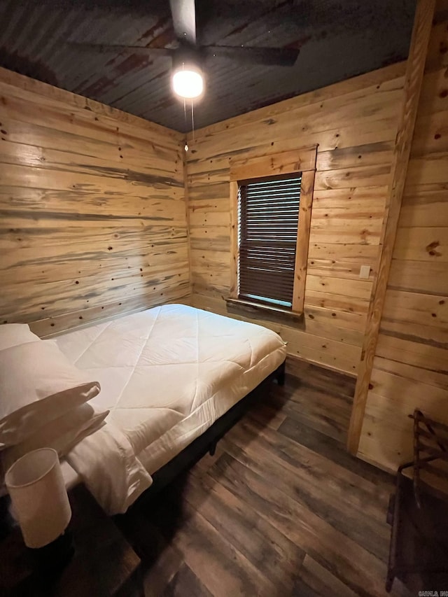 892 Hwy 375 E, Mena, AR 71953 - bedroom with ceiling fan, wooden walls, and wood finished floors