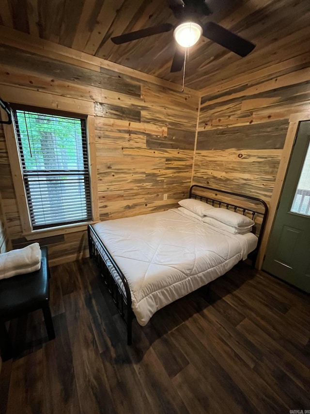 892 Hwy 375 E, Mena, AR 71953 - bedroom featuring wooden ceiling, dark wood finished floors, wooden walls, and ceiling fan