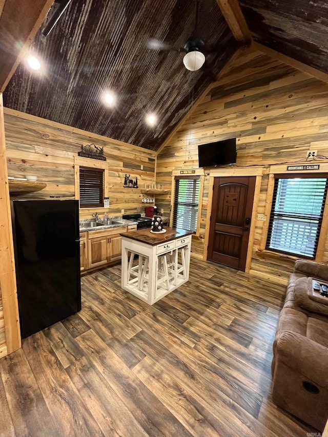 892 Hwy 375 E, Mena, AR 71953 - kitchen with butcher block countertops, freestanding refrigerator, dark wood-style flooring, wooden walls, and open floor plan