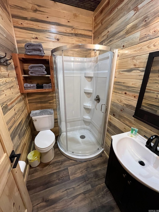892 Hwy 375 E, Mena, AR 71953 - bathroom with a stall shower, wooden walls, toilet, and wood finished floors
