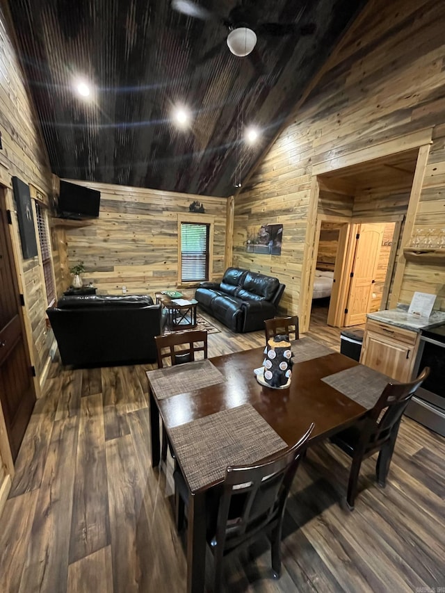 892 Hwy 375 E, Mena, AR 71953 - dining area featuring wood walls, wood finished floors, and high vaulted ceiling