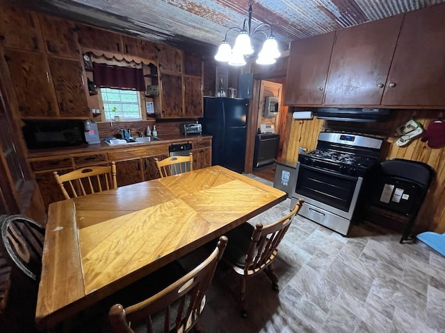 892 Hwy 375 E, Mena, AR 71953 - kitchen featuring pendant lighting, stone finish flooring, an inviting chandelier, a sink, and black appliances