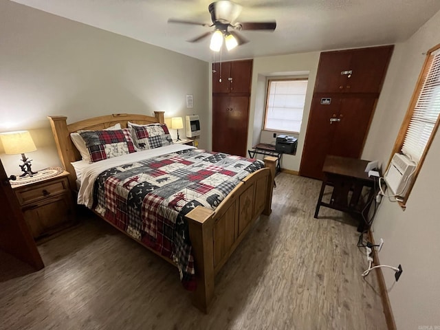 892 Hwy 375 E, Mena, AR 71953 - bedroom with heating unit, baseboards, light wood-type flooring, and a ceiling fan
