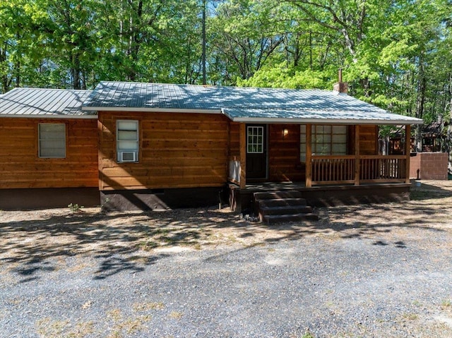 892 Hwy 375 E, Mena, AR 71953 - rustic home featuring a porch, metal roof, and a chimney