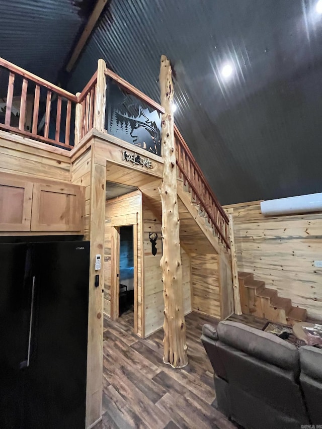 892 Hwy 375 E, Mena, AR 71953 - living area with wood walls, wood finished floors, lofted ceiling, and stairs