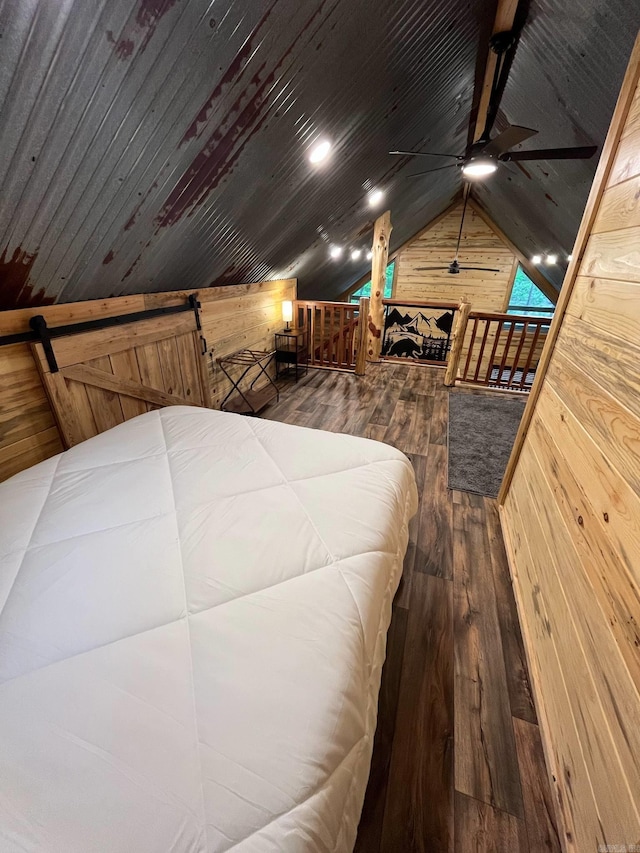 892 Hwy 375 E, Mena, AR 71953 - bedroom featuring vaulted ceiling, wood walls, and hardwood / wood-style floors