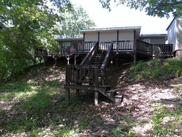 rear view of house featuring stairway and a wooden deck