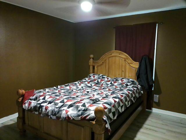 bedroom featuring ceiling fan, baseboards, and light wood-type flooring