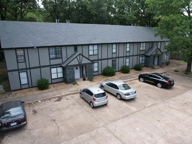 1906 W Matthews Ave, Jonesboro, AR 72401 - exterior space featuring uncovered parking, a shingled roof, and stucco siding