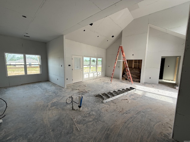 unfurnished living room featuring vaulted ceiling
