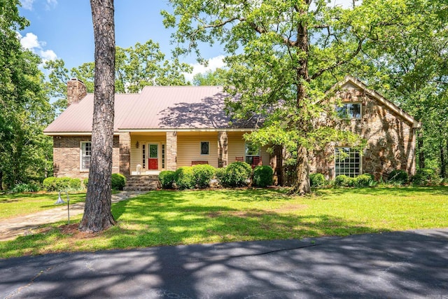 1494 N Miller Point Rd, Quitman, AR 72131 - view of front of property with a chimney, a front yard, stone siding, and metal roof