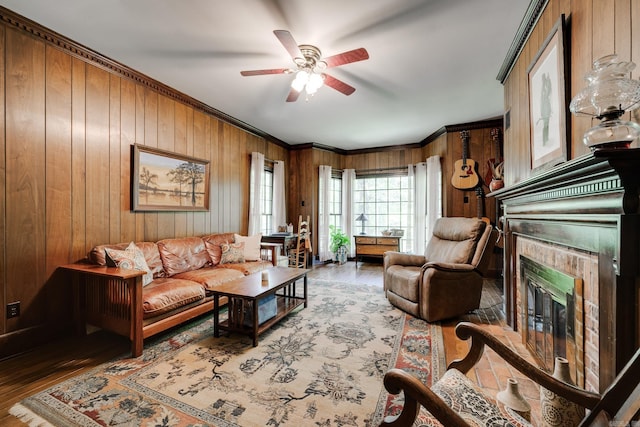 1494 N Miller Point Rd, Quitman, AR 72131 - living area featuring ornamental molding, a glass covered fireplace, ceiling fan, wooden walls, and wood finished floors
