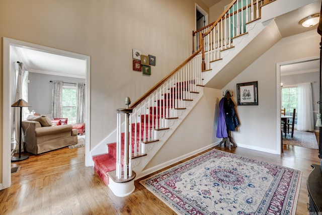 1494 N Miller Point Rd, Quitman, AR 72131 - stairs featuring crown molding, baseboards, a healthy amount of sunlight, and wood finished floors