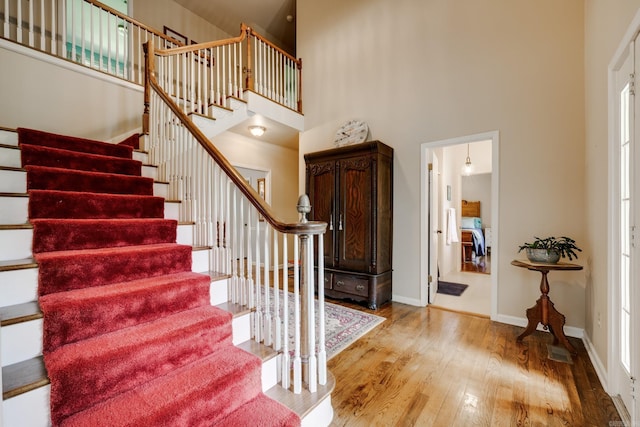 1494 N Miller Point Rd, Quitman, AR 72131 - foyer entrance with baseboards, stairs, a towering ceiling, and wood finished floors